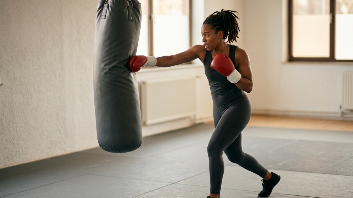 Boxer driving a hook into a heavy bag