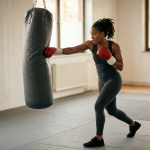 Boxer driving a hook into a heavy bag